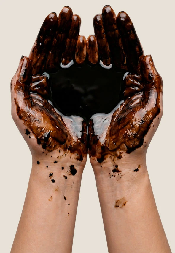 Cupped hands covered in crude oil