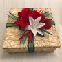 Wrapped for the holidays. 12 x12 x 4" straw basket decorated for the holidays with red and white flowers, and green ribbon. 