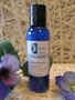 Peppermint foot lotion in a blue Blissful Balance bottle with purple flowers