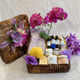 Our Relaxation Spa collection is in a medium brown handmade woven basket which has a matching lid decorated with silk flowers and ribbon. The basket is filled with natural hand and body products.