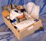 Large basket filled with bath pillow, white  robe, and spa products.
