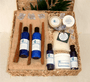 Wicker basket filled with blue soap and lotion bottles and other spa products.