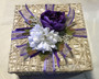 Wicker basket wrapped with purple ribbons and flowers