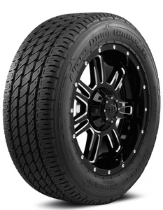A Nitto Dura Grappler G3 highway tire on a black rim over a white background. A Nitto Dura Grappler G3 highway tire on a black rim over a white background.