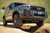 Gray toyota Land Cruiser crossing a small gap off road. Gray toyota Land Cruiser crossing a small gap off road.