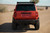 The rear of a modded Lc250 Land Cruiser in the sandy dessert with a sunny background. The rear of a modded Lc250 Land Cruiser in the sandy dessert with a sunny background.