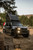 Front end of a Toyota J250 series Landcruiser with its headlamps on and a tent on its roof. Front end of a Toyota J250 series Landcruiser with its headlamps on and a tent on its roof.