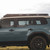 A side profile of the Heritage Blue FE 250 series Land Cruiser with the UpTop Overland roof rack on top.