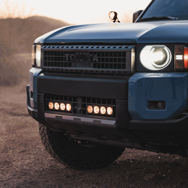 A heritage blue LC250 with KC HiLites grill / bumper flex era LED light bar kit installed.