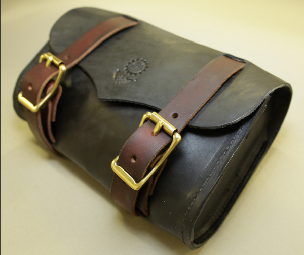 A Black Harley Tool Roll with dark brown leather straps