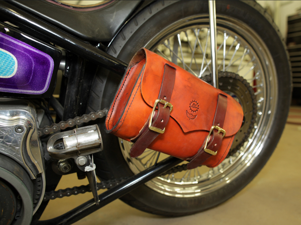 Leather Tool Roll shown on the side of a Harley 