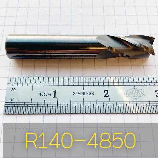 Refurbished End Mills R140-4850, a metallic cutting tool with a spiral flute design, placed on a ruler for size reference, suitable for machining applications.