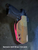 OWB holster with Nemesis Wolf fabric wrap, hot pink Kydex shell, adjustable retention, optic cut, and Tek Lock style belt attachment.