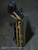Green leather wrapped dual-layer holster with glow-in-the-dark outer layer and liquid gold interior, mounted on a gold 1911 with QLS fork attachment.
