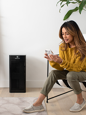 MA-40 air purifier in room with women sitting next to it on her phone