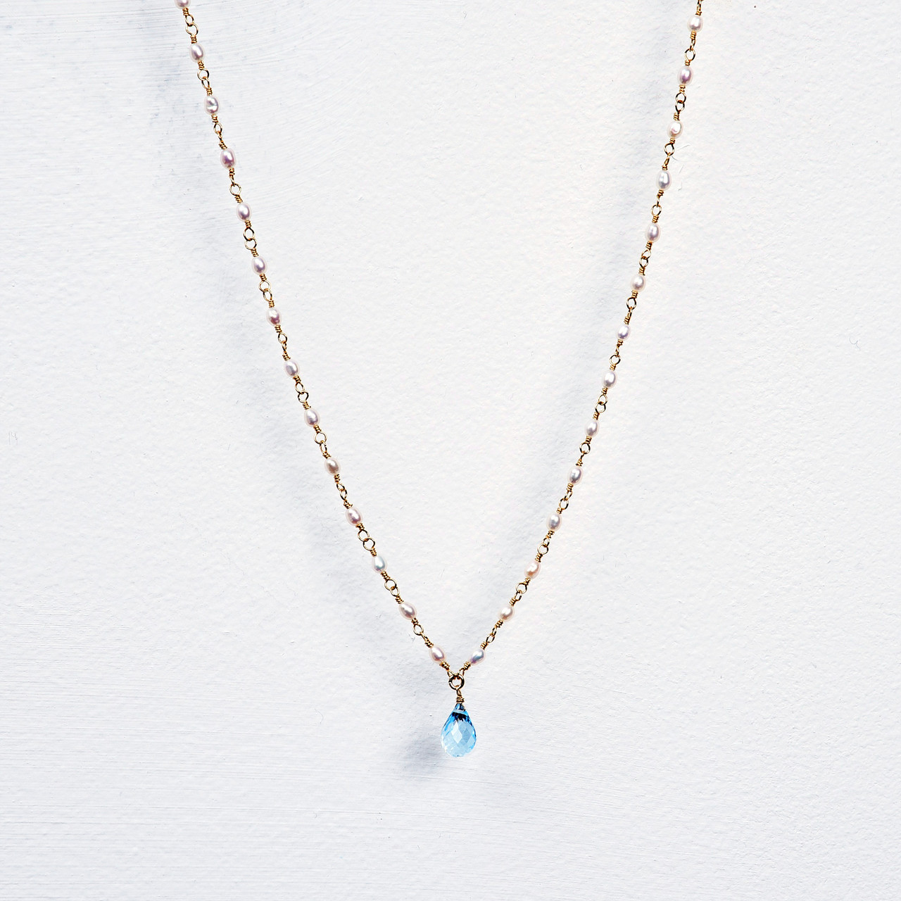 14K gold fill with a blue topaz pendant