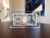 Japanese 1000 yen note displayed in a premium currency display frame