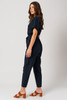 Picture of woman wearing a short sleeve linen navy jumpsuit