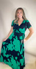 Picture of woman wearing a black and green floral short sleeve maxi dress