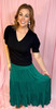 Picture of woman wearing a jade green tiered maxi skirt