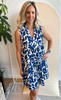 Picture of woman wearing a navy and white floral sleeveless tiered swing dress