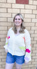 Picture of woman wearing a bright floral accent button-front cardigan