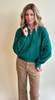 Picture of a woman wearing a quarter zip sweatshirt in hunter pine green