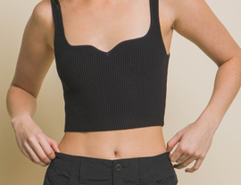 Picture of woman wearing a ribbed black sweetheart crop top