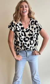 Picture of a woman wearing a short sleeve leopard print blouse