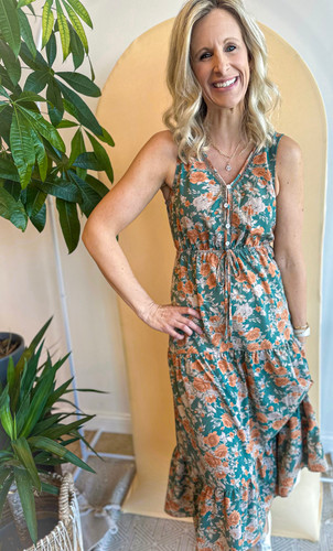Picture of woman wearing a dusty teal midi floral dress