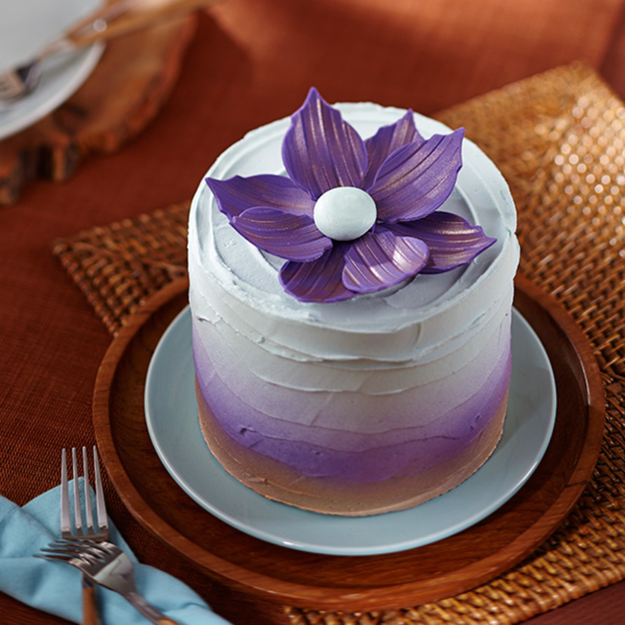 Premium Photo | A purple cake with purple flowers on top of it.