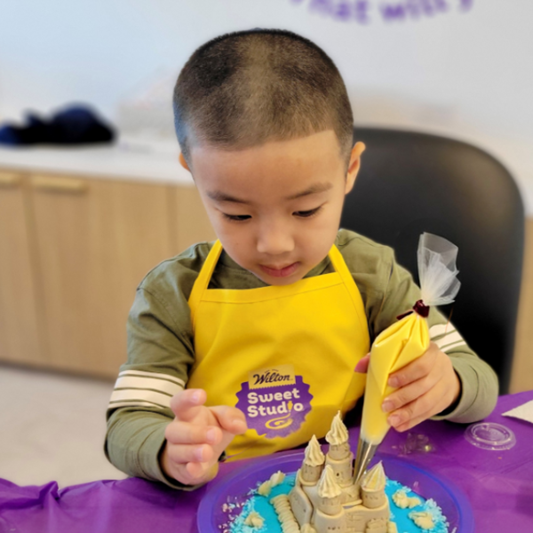 Young kid decorating cookies at Wilton Sweet Studio in Naperville, IL