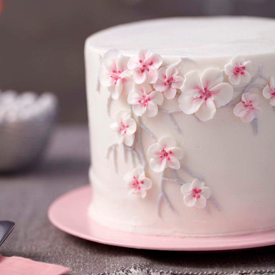 Premium Photo | A cake with cherry blossoms on top