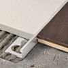 Straight edge tile  edging for for creating uncoupling joints between floor sections in similar or different materials.