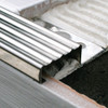 Tile-in stair nosing for, defining and protecting ceramic tile, marble, stone and other coverings on stairs and steps