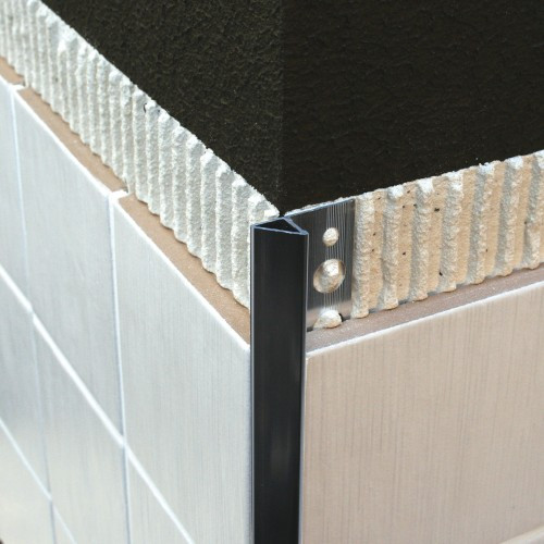 Aluminium triangular profile giving a stylish bevelled edge to tiled corner.