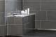 Aluminium quadrant tile trim creates decorative strips and facilitates top finish of ceramic edges in bathrooms.