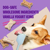 Product infographic for Old Mother Hubbard dog biscuits featuring vanilla yogurt icing, showing a Corgi licking icing from a spatula next to bone-shaped treats.
