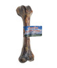 Product photograph of a real, smoked lamb femur dog chew bone standing vertically against a solid white background. The natural bone has a dark brown, roasted color from the smoking process, with visible textures on the joint ends and shaft. It is tightly wrapped in clear protective plastic. A blue rectangular label is wrapped around the center of the bone, featuring red and white text that reads "Smoked Lamb Femur" against a graphic background of a blue sky with white clouds.