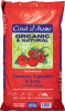 Front packaging of a large bag of Coast of Maine fertilizer against a white background. The bag is bright red with a prominent lime green and dark blue center label block. Cursive white text reads "Coast of Maine," followed by large dark purple text reading "ORGANIC & NATURAL." Below the brand name is an illustration of bright red tomatoes on a green vine with leaves. The lower half of the bag displays text reading "FERTILIZER FOR Tomatoes, Vegetables & Herbs" with the formula "4-5-4 (8% Calcium)" and the line "PROMOTES VEGETATIVE GROWTH, FLOWERING & FRUITING." Three small white line drawings illustrate a tomato, a carrot, and herbs next to an icon reading "100% OCEAN & LAND INGREDIENTS." The bottom corner lists "NET CONTENTS 12 LBS (5.44KG)" alongside a product barcode.