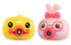 Product photograph of two cartoon animal-shaped bubble-blowing machines side-by-side against a plain white background. On the left is a bright yellow duck machine with big black eyes and an orange beak that acts as the bubble nozzle. On the right is a pink rabbit machine featuring pink bunny ears, a dark pink bow, printed red glasses frames, blushing cheeks, and a dark pink circular nose that serves as the bubble nozzle.