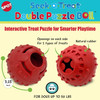 An informational e-commerce product graphic for the SPOT Seek-a-Treat Double Puzzle Ball against a cream and teal background. The image showcases two distinct views of a textured red rubber ball with text callouts highlighting "Openings on each side for 2 types of treats" and a "Natural rubber" construction. The graphic includes labels indicating a 3.25-inch size and notes that it is designed "FOR DOGS UP TO 50 LBS."
