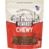 A 25-ounce pouch of Wholesomes Rewards Chewy Sticks with Beef Protein dog treats. The packaging features a tan upper section with a farm illustration and a red lower section with a clear window showing the stick treats inside next to a line drawing of a cow.