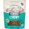 A 7-ounce pouch of Wholesomes Rewards Chewy Bites with Whitefish Protein dog treats. The packaging features a tan upper section with a farm illustration and a teal lower section with a clear window showing the small bite-sized treats inside next to an illustration of a fish.