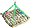 Hanging seagrass climbing mat for birds, suspended by green plastic chains decorated with colorful toys and charms.