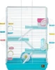 A front product photograph of a white wire multi-level small animal cage with a bright teal plastic base, isolated against a white background. The cage features light blue platforms, white ramps, a blue exercise wheel, a pink hideaway house, and clear play tubes connected along both outer sides.