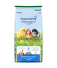 A bag of Nutrena NatureWise Medicated Chick Starter Grower 18% Protein Crumble feed featuring three young chicks in a grassy field, isolated against a white background.
