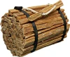 A bundle of natural fatwood firestarter sticks bound with black straps and a rope handle, isolated against a white background.