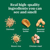 An ingredient infographic titled "Real high-quality ingredients you can see and smell" displaying oatmeal, peanut butter, roasted peanuts, brown rice, and chicken meal on a green background, isolated on a white background.