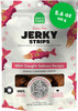 A 5.6 oz pouch of Open Farm Grain Free Jerky Strips Wild-Caught Salmon Recipe dog treats featuring salmon illustrations, a bright green 5.6 oz badge, and a clear window displaying jerky strips inside, isolated on a white background.